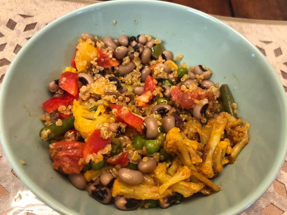A bowl of veggies with quinoa that looks colorful